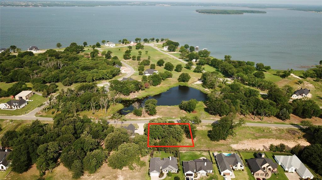 Nearly half an acre in Cedar Creek Landing with beautiful peek-a-boo water views of Cedar Creek Lake and the neighborhood pond. Set at a higher elevation with a strong building site and a few mature trees, this lot offers an ideal opportunity to capture water views and sunset skies from your future home. Cedar Creek Landing is a gated community with upscale amenities including a clubhouse, infinity-edge pool, boat launch, boat slips, and a neighborhood pond. Enjoy quick access to the surrounding lake area and an easy drive to the DFW metroplex.