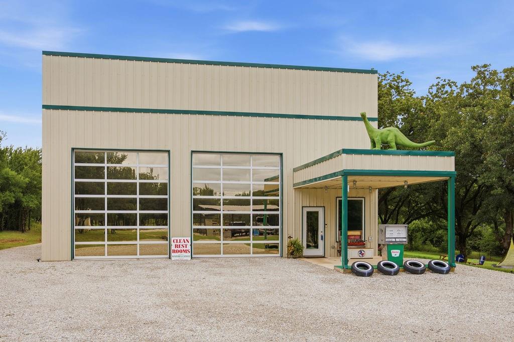 Where country living meets wide-open versatility. Tucked into nearly 3 wooded acres (2.92) in peaceful Wise County, this one-of-a-kind 2022 shop-style home blends industrial cool with comfortable living—and it does it almost entirely off the grid.
Start with the power: 60 solar panels paired with 3 Tesla Gen 3 batteries generate more electricity than the home typically needs, feeding the surplus right back into the grid. Water comes from a private well drilled 400 feet into the Trinity aquifer, served by a stand-alone well house and full filtration system. Lower your bills and live with real independence.
Inside, nearly 2,979 square feet is laid out shop-style for maximum flexibility. The cavernous main level (with a soaring 43x59 garage - shop, car lifts, and polished concrete) is a dream for collectors, gearheads, and hobbyists, while a dedicated first-floor office keeps work close to home. Upstairs, the living quarters feel bright and modern: an open living room, full kitchen with built-in cabinets, a primary suite with ensuite bath and separate shower, plus luxury vinyl plank and tile throughout. 2 bedrooms, 1.5 baths, central heat and air.
Parking is virtually unlimited—6-car garage, 4-carport, 12 covered spaces total—with room outside for RVs, trailers, and toys. The grounds are dotted with mature trees, gathering spots, and play areas, all set behind a gated entrance.
Metal roof and siding, slab foundation, Boyd ISD. Whether you're chasing a workshop, a homestead, or a property unlike anything else on the market, this one delivers
