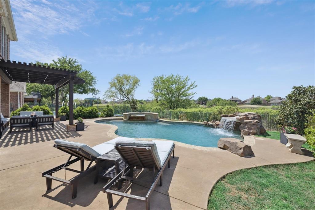 Welcome to your dream home, nestled on the 8th hole of the prestigious Trails of Frisco Golf Course! This East-facing stunning residence offers breathtaking views, a thoughtfully designed layout, and upscale finishes that blend comfort with style. As you step inside, you're greeted by beautiful wood floors throughout the main level and a stacked formal living and dining area, perfect for entertaining or creating a welcoming entry. The heart of the home features a spacious, open-concept living room with a cozy fireplace and large windows that showcase serene views of the backyard oasis and golf course beyond. The chef-inspired kitchen opens seamlessly to the living area and boasts white cabinetry, subway tile backsplash, bar seating, and decorative lighting—ideal for everyday living and entertaining alike. A flex room on the main floor offers the versatility of a guest bedroom or a private office. Upstairs, you’ll find a generous game room, a luxurious primary suite featuring dual sinks, a soaker tub, and a separate shower, plus three additional well-sized bedrooms that provide plenty of space for family, guests, or a home office setup. Step outside to your personal paradise, complete with a sparkling pool, soothing hot tub, and a charming pergola-covered patio, ideal for relaxing or hosting guests year-round. Located close to the community clubhouse, neighborhood parks, and top-rated Frisco schools, this home also offers easy access to premier dining, shopping, and entertainment options—including the world-class PGA Frisco complex. This one has it all—views, lifestyle, location, and luxury!