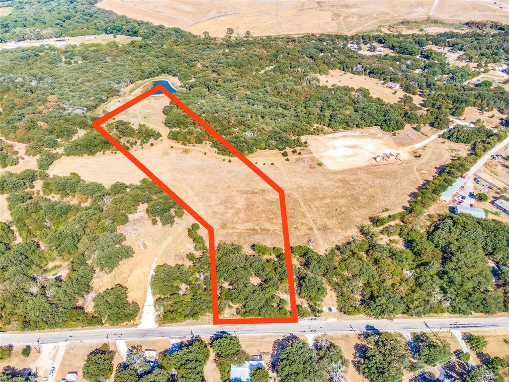 County land with no HOA! Seller is pulling 9.989 acres from a larger parcel to sell. Plat and survey are awaiting final approval. Large oak trees, many deer, a secluded space with shared-ownership of the deep pond for fishing! Horses permitted! Great road frontage and easy access to I-35. (Boundary lines on photo are approximate and subject to approval.) Can possibly be combined with the lot next to it.