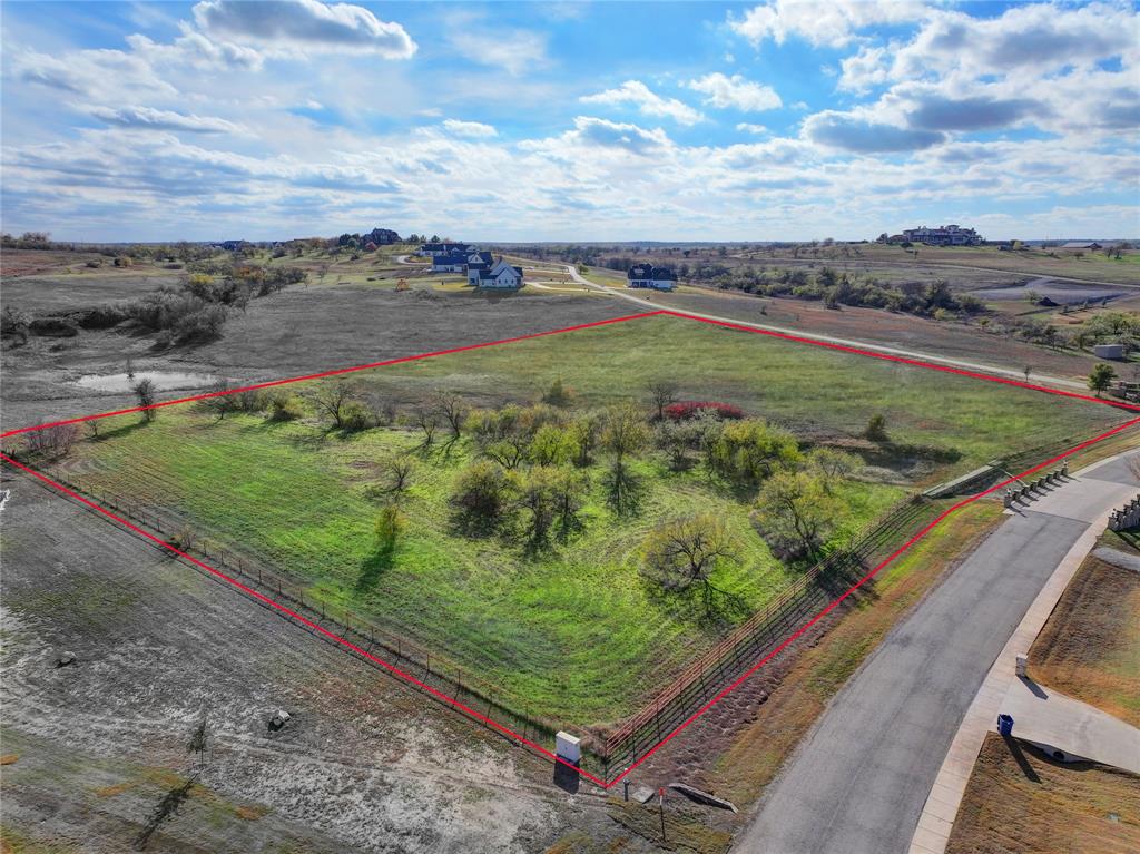 SELLER OFFERING 1 YEAR HOA DUES PAID IN FULL FOR ACCEPTABLE CONTRACT BY JANUARY 31, 2024. Nestled within the highly coveted and secure gated community of La Madera in Aledo, this remarkable 5.08-acre corner lot presents a unique opportunity to build your dream home in a setting of unparalleled beauty and tranquility.  Enjoy breathtaking water views that add an extra layer of serenity to your daily life, creating a picturesque backdrop for your new home. The property boasts fencing on three sides, providing a sense of security and delineation while maintaining an open and inviting atmosphere. La Madera offers 2 acre minimum lots with beautiful estate homes throughout. Existing stone entrance is an elevated accent already existing on the property. Building requirements include 3,000 sq ft minimum. Outbuilding permitted. No city taxes! Survey is available. PHASE II of La Madera