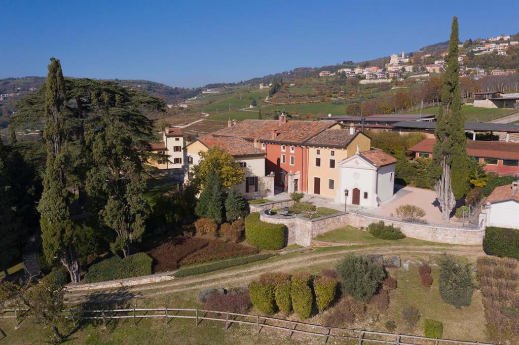 SET AMID THE ROLLING HILLS OF VALPOLICELLA, JUST OUTSIDE OF VERONA ITALY, Villa La Pavarana stands as one of the most prominent historic estates of Northern Italy. Dating to the 15th century, this noble property has long been shaped by heritage, landscape, and quiet refinement. Its past lives on in frescoed halls, arched loggias, vaulted ceilings, and sunlit courtyards, all carefully restored to honor history while embracing modern comfort.
   Passing through the gates, time seems to slow. Hand-hewn stone, classical proportions, and tall windows create an atmosphere that feels both gracious and welcoming. Light moves gently through the villa, softening interiors that were designed not simply to impress, but to invite. From the grand salons to the shaded loggias, every space reflects a sense of calm, balance, and lived elegance.
   The estate extends across approximately 111 acres, with more than 30,000 square feet of living space, encompassing a Romanesque villa, chapel, restored rural buildings, and, at the north end of the estate, Cà Nova with its own stories to tell. The Villa alone has 11 bedrooms and 14 elegant marble-clad baths amongst its 50 rooms. Beyond the architecture, the land unfolds in vineyards producing Valpolicella DOC grapes, olive groves, orchards, woodland, and a landscaped park with a spring-fed lake, a setting of rare beauty and privacy.
   There are places that spark the imagination, and others that settle into the heart. La Pavarana does both. It carries its history lightly, offering a life measured not in hurry, but in moments — footsteps on cool stone, afternoon light across a wall, laughter under a canopy of stars. For those seeking more than a residence, La Pavarana is a rare inheritance: a home, a landscape, and a way of life.