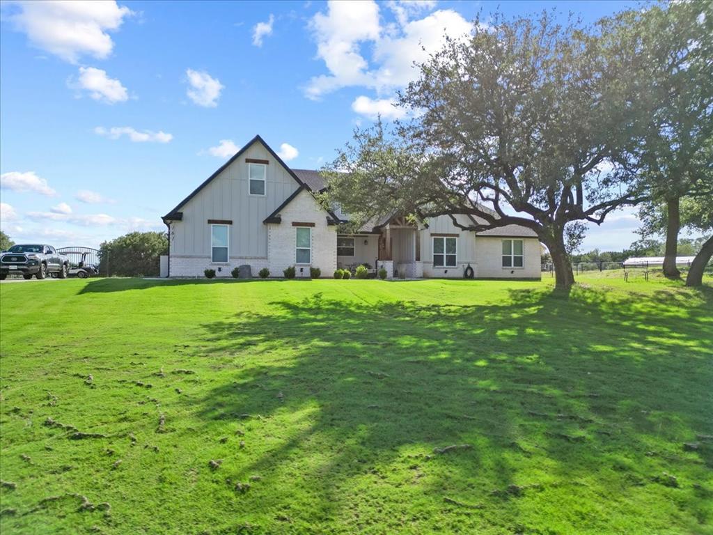 Welcome to this beautifully designed 4-bedroom, 2.5-bath home in the highly desirable Rolling Creek Ranch community on the east side of town. Thoughtfully crafted with an open-concept layout, this home offers the perfect blend of comfort, style, and functionality. The spacious living area features a cozy fireplace and flows seamlessly into the kitchen and dining spaces, creating an ideal setting for everyday living and entertaining. A dedicated media room provides the perfect space for movie nights, game days, or relaxing or entertaining. Throughout the home, stunning finishes and warm wood accent touches create an elevated yet inviting atmosphere. The primary suite offers a peaceful retreat, while the additional bedrooms provide ample space for guests, or a home office. Step outside and enjoy the beautifully landscaped yard, complete with a large covered patio designed for outdoor gatherings and quiet evenings alike. The newly installed fencing, an irrigation system, and charming greenhouse add both beauty and functionality to the property. Situated on the Fort Worth side of town, Rolling Creek Ranch offers scenic rolling terrain, a peaceful setting, and convenient access to shopping, dining, entertainment, and major commuting routes. Enjoy the tranquility of country-style living while remaining within an hour of Fort Worth. This impeccably maintained home is truly move-in ready and offers the perfect combination of modern farmhouse charm, thoughtful upgrades, and exceptional outdoor living.