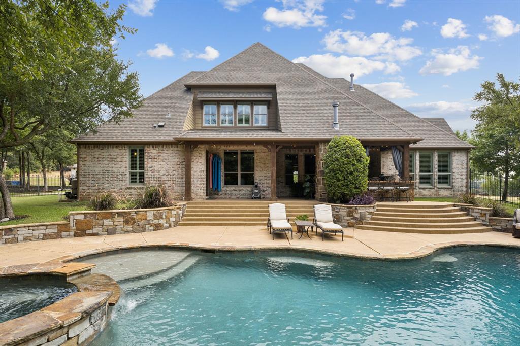 Welcome to your dream home in the heart of Southlake with Open enrollment for the esteemed Carroll Independent School District. This stunning 5-bedroom, 5-bathroom residence offers a plethora of luxury features and a prime location overlooking Cliffs Park at Clariden Ranch. Spanning 5,013 square feet, this home boasts a formal dining room with an adjacent Butler’s pantry and wine bar, a private study with custom built-ins, and an inviting open-concept kitchen and family room adorned with a stone fireplace and expansive windows that showcase resort-style backyard views. The chef’s kitchen is a culinary delight, featuring a spacious island with seating, a farm sink, stainless steel appliances, gas cooktop, double ovens, a pot filler, and a built-in refrigerator with walk-in and Butler’s pantry. The first floor hosts a large media room perfect for movie nights, while the second floor includes three additional bedrooms and 3 baths, a living room with a wet bar and a versatile bonus room—ideal as an exercise room, dance studio, or additional bedroom. Retreat to the spacious primary ensuite with separate vanities, jetted tub and shower. Second bed down is split providing comfort and privacy for all family members and guests. Enjoy your own resort-style backyard featuring a second kitchen, stone fireplace, pool with spa and waterfall, fire pit, and multiple serene seating areas nestled in a park-like setting. This dynamic property rests just minutes away from upscale shopping, dining, entertainment, and cultural amenities of Southlake Town Square and quick access to DFW Airport offering both privacy and accessibility. With its exquisite craftsmanship and luxurious amenities, this property is more than a home—it's a lifestyle. Experience the best of Southlake living in this magnificent residence.