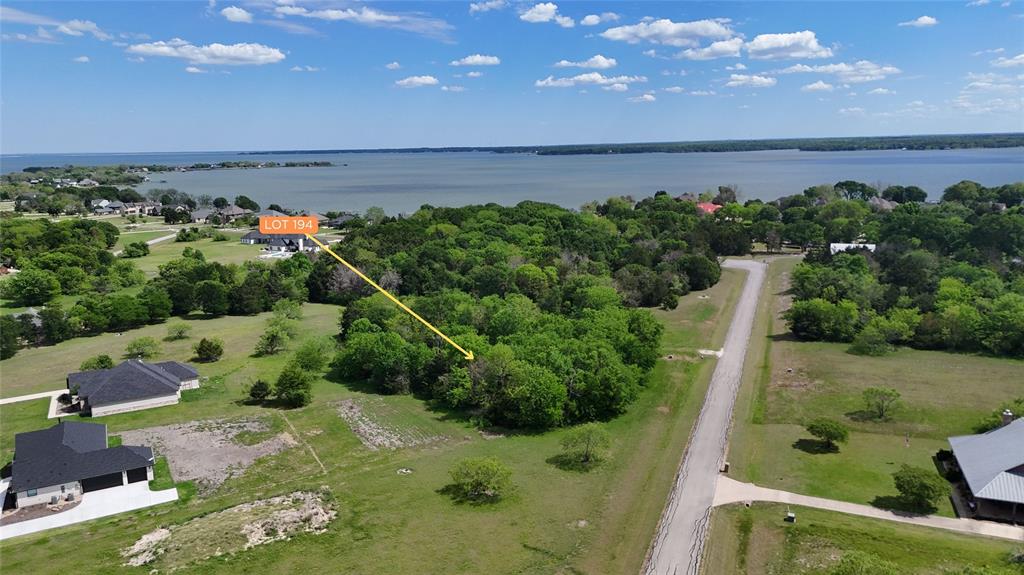 Tucked within the rolling landscape of The Shores on Richland Chambers Lake, Lot 194 offers a beautiful blend of natural beauty, privacy, and scenic lake-area surroundings. This 1.124-acre residential lot is gently contoured and richly wooded, creating a peaceful, park-like setting that feels both secluded and connected. Mature trees blanket the property, providing dappled shade, natural screening, and the perfect backdrop for a custom home thoughtfully nestled into the landscape.

From the lot, you'll be drawn toward the shimmering expanse of Richland Chambers Lake, visible just a from The Shore's community dock and park. The elevated feel and positioning within the community create a sense of openness, with long sightlines, soft breezes, and ever-changing light reflecting off the water. Whether enjoyed from a future front porch, back patio, or second-story balcony, the setting invites relaxed mornings and quiet evenings surrounded by nature.

The lot’s generous size and organic shape offer flexibility for home placement, outdoor living spaces, and preserving the natural canopy that makes this property so appealing. Neighboring custom homes and paved roads reinforce the established, well-maintained character of the subdivision, while the surrounding greenery adds to the feeling of calm and retreat.

Located in Mildred ISD, this interior lot delivers the best of lake-community living—scenic views, privacy, and room to breathe—without the upkeep of direct waterfront ownership. Whether you envision a refined primary residence or a tranquil weekend escape, Lot 194 provides an inviting canvas in one of Richland Chambers Lake’s most desirable gated communities.