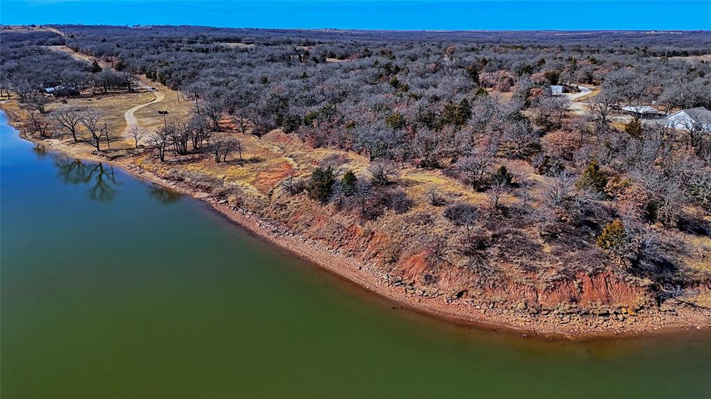 Rare 4.86 acre lakefront parcel offering versatile development opportunities ideal for a custom lake home or private estate, a boutique marina, or a thoughtfully planned small townhome community. Seller has already partnered with an engineer and holds initial site and townhome plans. Quiet, scenic setting with easy access and strong potential for residential or recreational development. Contact listing agent for plans, site details, and next steps.
This property is the perfect blend of natural beauty and tranquil living with this exceptional lakefront property set on 4.86 acres of gently rolling land. Boasting breathtaking water views, direct lake access, and abundant open space, this property offers the ideal setting for your dream home, vacation retreat, or private getaway.
The land comes equipped with a recently serviced water well.  With plenty of room for a custom home, guest house, or recreational amenities, you’ll enjoy unmatched privacy, pristine surroundings, and endless outdoor possibilities—from boating and fishing to peaceful evening walks by the water.
Located in a highly desirable area, this lakefront haven combines the serenity of country living with convenient access to nearby amenities, shopping, and schools. Whether you’re an investor, builder, or nature enthusiast, this property represents a rare opportunity to own a prime piece of waterfront real estate.
Features:
• 4.86 acres with stunning lake frontage
• Recently serviced water well
• Expansive open space for building or recreation
• Private, peaceful setting with convenient access to town.      
Embrace the lifestyle you’ve always imagined—your lakefront escape awaits!
