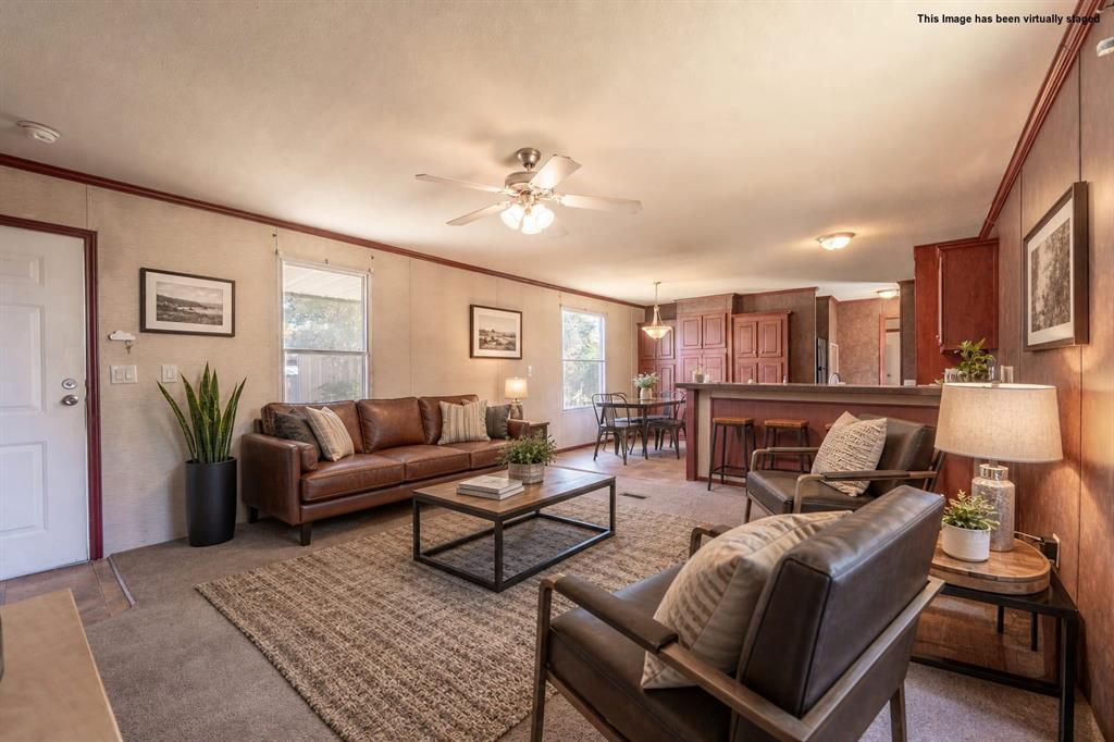 Affordable lake living meets everyday comfort in Pelican Bay — a welcoming lakeside community just moments from Eagle Mountain Lake. This well-maintained 3-bedroom, 2-bath manufactured home offers approximately 1,216 sqft of functional space on a .177-acre lot with no HOA & direct community access to a private boat ramp & fishing pier. Inside, a split-bedroom floorplan delivers comfort & privacy throughout. The open-concept layout connects the living, dining, & kitchen areas for easy everyday flow & effortless entertaining. The kitchen features black appliances, ample counter space, a high-top breakfast bar, & a hidden cabinet that opens to a cleverly combined pantry & laundry room — a smart use of space that keeps the home organized & functional. The primary suite is privately positioned & includes a large walk-in closet, dual sinks, a garden soaking tub, & a separate shower. Two secondary bedrooms & a full guest bath are located on the opposite side of the home, offering flexibility for family, guests, or a dedicated workspace. Outdoor living is easy with covered porches at both the front & rear entrances, a 2-car carport, & a flat, usable yard with room for pets, gardening, or recreation. Pelican Bay residents enjoy the lake lifestyle while staying close to local conveniences in nearby Azle — grocery stores, shopping, & dining all within easy reach. Whether you're searching for a primary residence, weekend retreat, or investment opportunity, this home delivers value, location, & flexibility with no HOA restrictions.