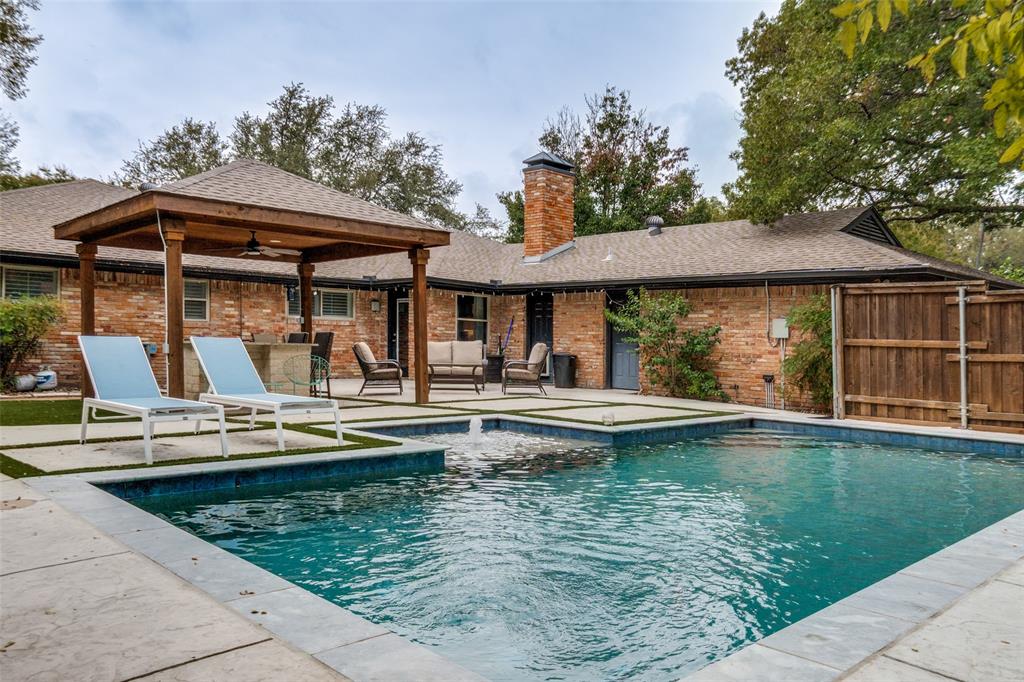 Back and better than ever after completing a full sewer line replacement.This is your chance to et into Chapel Downs with a dream pool and updated plumbing! Nestled on a quiet cul-de-sac in Northwest Dallas, this thoughtfully updated single-story home blends warmth, functionality, and style throughout. The open-concept floor plan creates a natural flow between the kitchen, dining, and living areas, making it perfect for everyday living or entertaining. Exposed wood beams, rich hardwood flooring, and a custom stone fireplace anchor the spacious main living room, while oversized windows flood the home with natural light. The kitchen is both beautiful and practical with granite countertops, stainless steel appliances, soft-close cabinetry, and an extended island that provides seating and ample prep space. A built-in desk area and breakfast nook offer versatility for work-from-home or casual dining. The home features four comfortable bedrooms and three updated bathrooms, including a primary suite with a modern en-suite bath that showcases dual vanities, marble counters, and a glass-enclosed shower. Step outside to your private backyard oasis complete with a sparkling pool and spa, an outdoor kitchen under a cedar-lined pergola, and multiple lounge areas designed for relaxation or entertaining. Pet-friendly turf accents and mature trees provide beauty with minimal upkeep. Ideally located near private schools, the Northaven Trail, and major Dallas corridors, this property offers a rare combination of style, convenience, and resort-like living, all in one exceptional package.