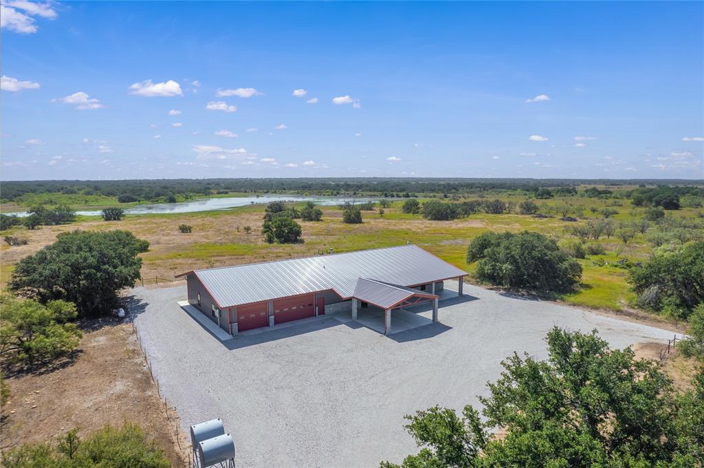 Stunning is the best way to describe this place. This property has a magnificent 4 bedroom two and a half bath Barndominium built in 2021. Picture yourself on the large back porch enjoying the view of the private lake. The 230 acre property is scattered with large oak tree clusters as well as other native hardwoods. Game is abundant as well, white tail, dove, quail, duck, and hogs are some of the native animals that call this place home. Great fences, abundant water, and great native grasses along with working pens and hay barn make this a cattlemans dream. Give us a call today to schedule a look at your new forever home!
