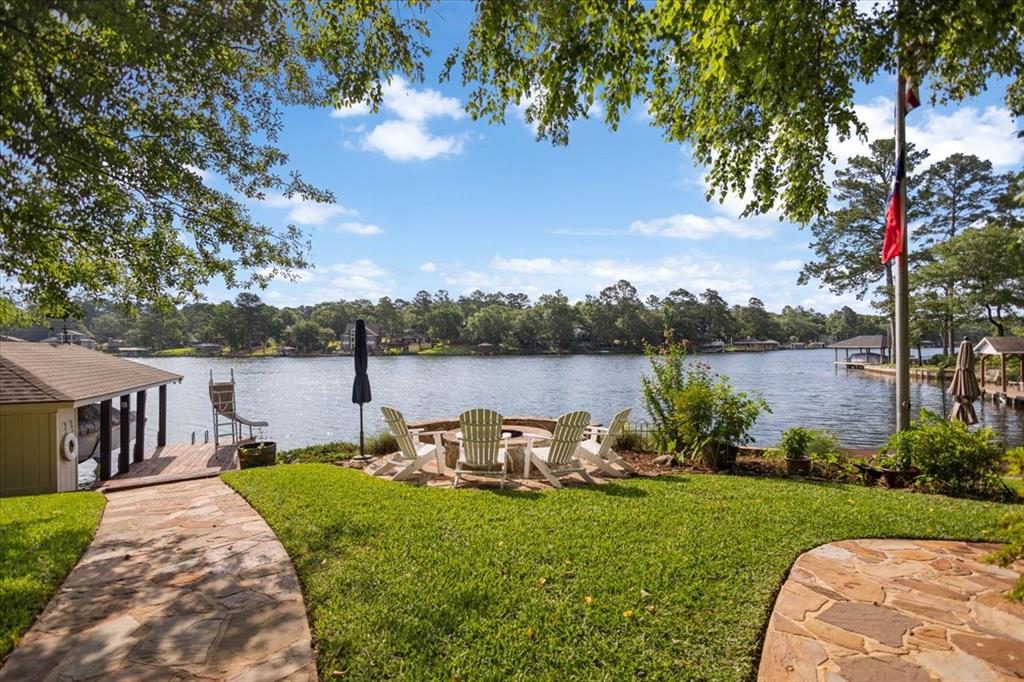 Experience lakefront living at its finest in this stunning 4-bedroom, 4.5-bath home situated on a rare double lot in Hideaway Lake. Designed to capture breathtaking water views, this home is filled with natural light and showcases the beauty of the lake from nearly every room. Inside, you'll find a dedicated office, a flexible formal living area, a spacious main living room with a cozy wood-burning fireplace, and elevator access to the second floor for added convenience. All bathrooms have been beautifully updated with timeless finishes, and one upstairs bedroom features custom built-in beds, perfect for guests or family.

Step outside to enjoy the ultimate waterfront lifestyle with an expansive deck, hot tub, multiple outdoor seating areas, and two private docks. One dock is ideal for relaxing by the water, while the second includes a new boat lift and slide for endless lake enjoyment. A charming bunk shed with electricity and a window unit provides additional flexible space for guests, hobbies, or a private retreat.

Additional features include a 3-car garage, lake-fed sprinkler system, and drip irrigation for flower beds. Whether you're searching for a full-time residence or a weekend getaway, this exceptional Hideaway Lake property offers comfort, convenience, recreation, and unforgettable waterfront views. Additional pictures available.