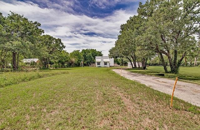 Welcome to this beautifully updated country home with private guest quarters, horse amenities and two storage buildings, all nestled among mature trees on approximately 2.69 acres in Mansfield ISD. Inside the main home, abundant natural light, soaring living room ceilings and a beautiful fireplace create an inviting atmosphere. The spacious kitchen has plentiful cabinetry, built-in buffet storage, updated countertops, appliances and generous prep space for everyday living and entertaining. The primary bedroom is located downstairs, while two oversized upstairs bedrooms each feature walk-in closets and two full bathrooms. Private guest quarters include a remodeled full bath, giving flexibility for guests, hobbies, office space or multigenerational living. Recent updates include metal roofing, foundation leveling to rear portion of main home, interior and exterior paint, flooring, countertops, appliances, bathroom updates, porch improvements and additional cosmetic updates. Outdoor features include a horse run in shelter, open green space, mature shade trees and two separate outbuildings for storage, hobbies or equipment. Enjoy peaceful country living with room to roam and endless possibilities to make this property your own.