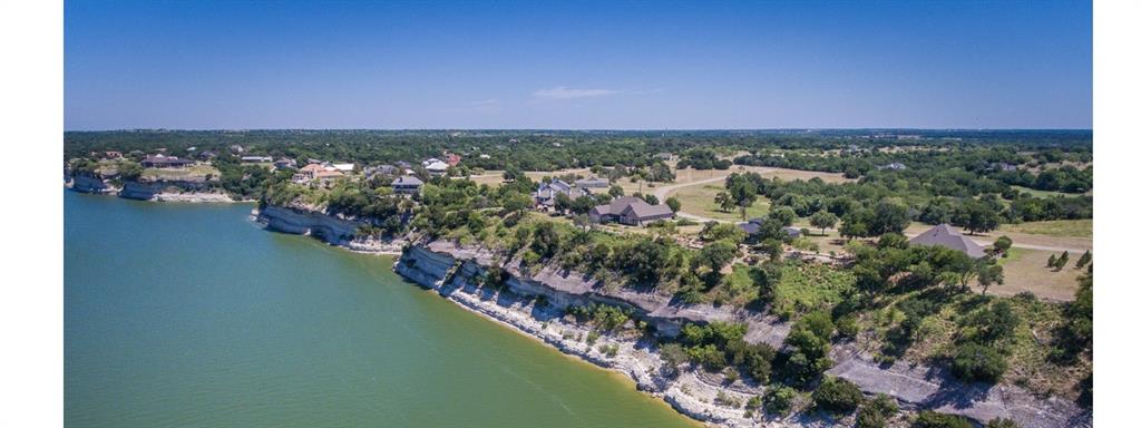 BUILD YOUR DREAM GETAWAY in the highly sought after WHITE BLUFF RESORT ON LAKE WHITNEY! This beautiful .18 acre vacant lot sits inside a premier gated community offering an unmatched blend of luxury, recreation, and natural beauty. PERFECTLY POSITIONED FOR BOTH WEEKEND ESCAPES AND FULL TIME LIVING JUST 90 MINUTES SOUTH OF DFW, 30 MINUTES NORTH OF WACO, AND 2 HOURS NORTH OF AUSTIN THIS COMMUNITY BLENDS TRANQUILITY WITH ACCESSIBILITY. White Bluff Resort is home to TWO TOP RATED CHAMPIONSHIP GOLF COURSES, A STATE OF THE ART FITNESS CENTER, and a resort style sanctuary perfect for unwinding. Enjoy endless amenities including HIKING TRAILS, HORSEBACK RIDING, A LAKEFRONT HOTEL, FOUR SWIMMING POOLS, THREE PICKLEBALL COURTS!. Pamper yourself at the onsite HAIR SALON AND SPA, dine at multiple onsite RESTAURANTS, or host events at the impressive conference center. Additional conveniences include RV parking, a dedicated fire department, and a care helipad for added peace of mind. Whether you’re planning a retirement retreat, vacation home, or investment build, this lot offers the ideal opportunity to create your perfect haven at Lake Whitney’s most desirable resort community.