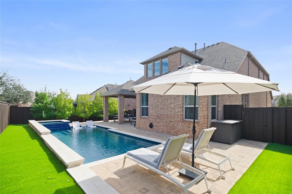 This absolute pristine Craig Ranch masterpiece in highly sought-after Southern Hills community blends luxury, and comfort within top-rated Frisco ISD. A beautifully tudor style home conveniently located right across from park delivering the ultimate backyard escape with everything needed for a perfect entertainment: an oversized backyard with extensive covered patio set up with a lounge & gourmet areas that open to a sparkling pool with spa surrounded by meticulously landscaped yard. Step into the home, and immediately feel the warmth and sophistication of the heigh ceilings, elegant dining room, an office, and wood floors throughout all social areas. The open floor plan seamlessly connects the kitchen, nook, and family room, creating an ideal space for both everyday living and entertaining. The kitchen is a chef’s dream at the heart of the home, equipped with top-of-the-line stainless steel appliances, luxurious Silestone countertops, a spacious center island, and custom cabinetry with hardware. The family room features custom shelving units, a contemporary stacked stone fireplace with gas logs adding to the cozy ambiance. There are 4 Bedrooms (master down), 3.5 bathrooms, a Gameroom, and a step down Media Room with 7.1 speakers! Enjoy a 3-car garage w hanging shelving for storage. This prime property boasts an excellent location near Highways 121 and 75, offering easy and convenient commuting. It is also close to top-rated schools, shopping centers, and a variety of dining options, making daily life effortless and enjoyable. You will be amazed!