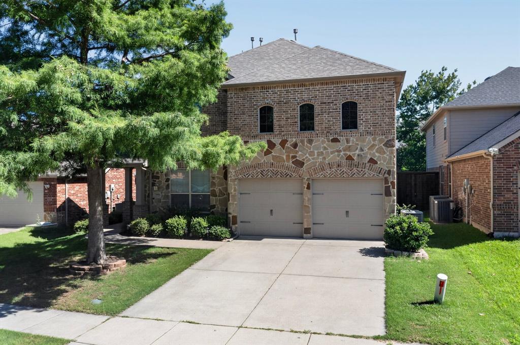Zoned to the highly sought-after Frisco ISD, this impressive 2,632-square-foot residence perfectly combines modern comfort with elite educational opportunities. Nestled on a desirable lot featuring a warm brick and stone accent exterior, this property offers enhanced privacy and additional yard space—perfect for growing families. The welcome begins on the deep-set front porch, surrounded by timeless stonework. Inside, a bright, sunlit foyer greets you with neutral tones and a classic wooden-railed staircase, creating an atmosphere that is both warm and elegantly structured.