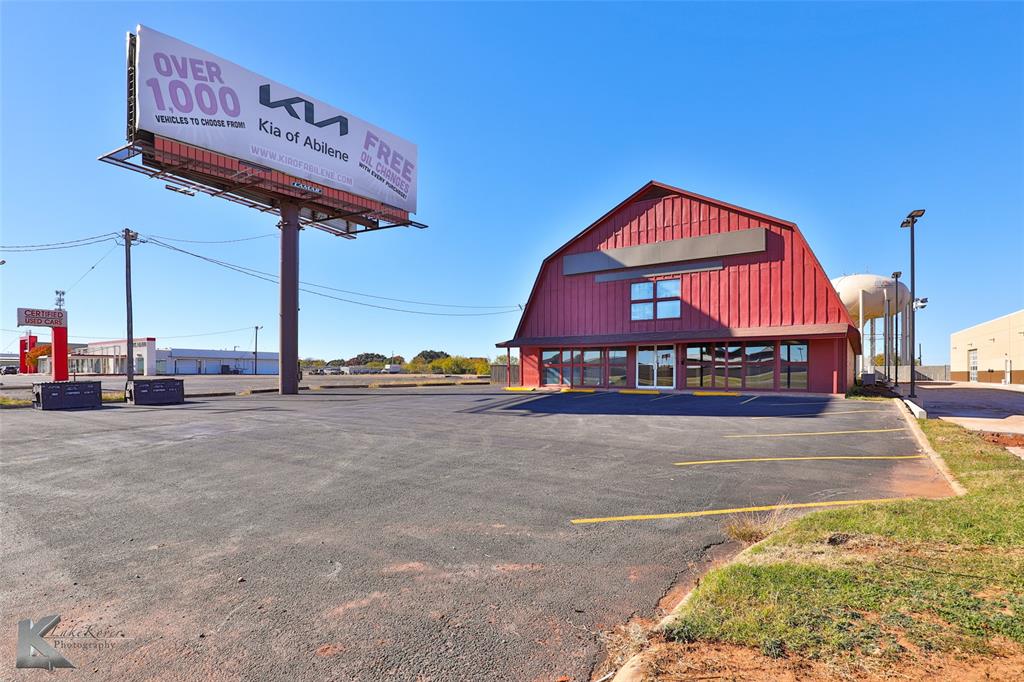 You have seen and heard about THE BIG RED BARN for years. Now is your time to OWN IT!! Do you need showroom, office, workshop and warehouse space? This property has it all! The Front door of the Red Barn faces EAST and invites your customers into a sprawling space for merchandise display. This portion of the building is 2-story. There are 2 staircases for access. The second floor is open in the middle allowing for a very high ceiling height for a portion of the 1st floor. There are a couple partitioned spaces for office and storage downstairs and even more upstairs.  If you continue through the building, straight back, you will find a transition area that will work well for a shop space, production area or flex space to be conformed to your needs. Just behind this middle section you will walk into the warehouse. Room for LOTS of product waiting to be purchased. There is a little bit of fenced yard just off of the warehouse and workshop for some secured outdoor staging. Let us schedule your showing to move you from dreaming to doing!