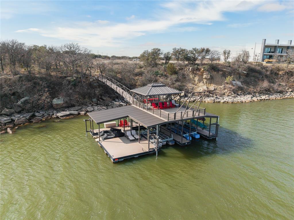 Stop Searching - Start Living Your Dream!

If you've been waiting for the perfect deep-water lot to build your dream lake house, your search ends here. Welcome to Reflection Ridge, the premier private gated subdivision within the exclusive Hideout Golf Course and Resort community on beautiful Lake Brownwood.

This one-acre, gently-sloping east-facing lakefront lot offers 244 feet of unobstructed shoreline - a rare find that combines privacy, stunning views and direct access to the water.

And the best part? Your dock is already here and ready for summer fun! No waiting, no hassle - just bring your boat, jet skis and family. The 51' x 33' two-slip aluminum dock, built by industry leader Floatation Systems, features a covered upper deck for relaxing and entertaining, mounted fishing lights for night fishing, spacious swim and fishing platforms, two covered jet ski ports, sun deck and super swing.

With 15-plus feet of water depth at the dock - even with the lake level down - this is true deep-water access!
Utilities? Already on site: water, sewer and electricity. The lot is cleared and ready for construction, so you can start building immediately.

Plus ownership includes access to award-winning amenities including free rounds of golf, driving range and putting green, fitness center, seven free nights in resort cabins and exclusive merchandise and club discounts.

This is more than a lot - it's a lifestyle. Imagine mornings on the lake, afternoons on the course, and evenings on your private dock.

Opportunities like this don't come often - especially with summer just around the corner. Act now and make Lake Brownwood your next backyard!