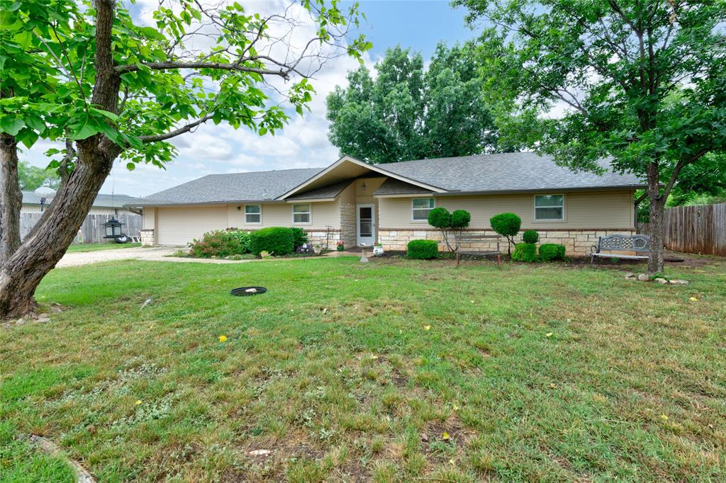Tucked into the peaceful, well-established community of Potosi — just south of Abilene city limits and within the highly sought-after Wylie ISD — 1033-A Wolfe Rd offers a solid, character-rich home on a generous 0.47-acre lot. This 3-bedroom, 2-bath home is built to last, with three sides clad in full rock and a freshly updated front featuring Austin Stone wainscot and cement board siding framed by beautiful landscaping and blooming crape myrtles that add standout curb appeal.
Inside, cozy carpet is in the bedrooms, while luxury vinyl plank flooring flows throughout the living areas, and a propane fireplace anchors the space with warmth and charm. The kitchen has been updated with granite countertops, and a new oven was installed in 2023. The garage has been freshly upgraded with a flake epoxy floor — a polished, durable finish that speaks to the quality of updates found throughout. Major systems have been carefully maintained: a brand-new HVAC was installed in 2025, ductwork was replaced in 2020, and a new roof was put on in 2023. Peace of mind comes standard here — the foundation was professionally stabilized by WestTech Foundation Repair in 2025.
Step outside and the property truly opens up. The grounds are graced with an impressive variety of mature trees — Red Oak, Mimosa, Redbud, Cottonwood, Pecan, and Catalpa — along with two producing apricot trees. In season, the pink crape myrtles and white Catalpa blooms put on a beautiful show. The expansive backyard offers plenty of room for pets, gardens, and homesteading pursuits. A 20x40 ft shop with a side awning provides serious workspace, while a solid 9x16 outbuilding with a concrete floor and double doors offers dedicated equipment storage.
Whether you are a hobbyist, a gardener, or simply someone who values space, privacy, and a well-cared-for home, this property delivers. Solid updates, a great lot, a wonderful community, and Wylie ISD — schedule your showing today, before someone else snatches this one up!