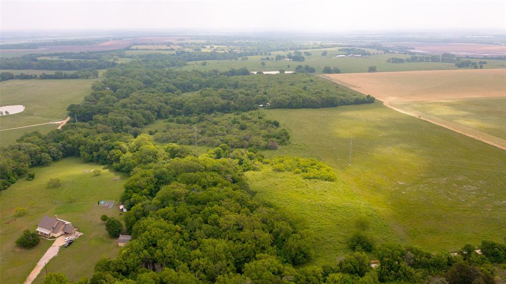 This beautiful 20-acre tract of land is a great opportunity for anyone looking for a large piece of land to call their own.
The property features a gently sloping terrain with some flat areas, making it ideal for a variety of uses, including
agriculture and residential. The land has a mixture of native grasses and beautiful old
pecan trees, providing plenty of room for grazing livestock or planting crops. The property also has a small pond on the
northern side, which could be used for fishing or livestock watering. Additionally, the land has access to electricity and
water, making it ready for development. Conveniently situated near the city of Ennis, provides easy access to shopping,
dining, and entertainment options. It is also just a short drive from the Dallas-Fort Worth metroplex, which is ideal for
those who want to enjoy the benefits of city living while still having the peace and quiet of a rural setting. NO SURVEY available