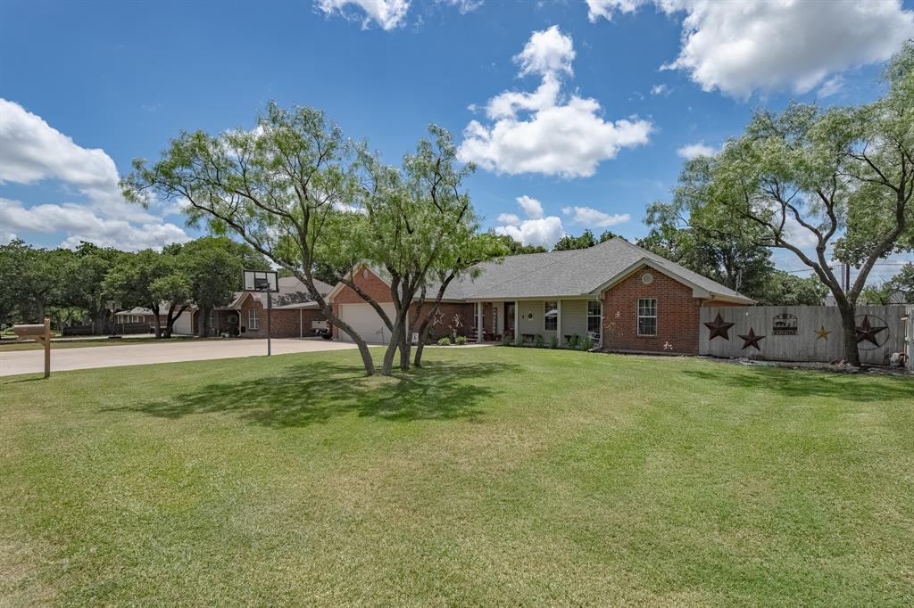 ***Property features a 50 foot well by White's Drilling in good working condition! Owners use well water for the lawn. The house is connected to city water!*** Situated in the heart of Clyde Bulldog territory is this beautifully maintained 4 bed, 2 bath single-story brick home with flex space currently used as an office in the established Tanglewood East neighborhood. Offering approximately 1,833 sq ft of comfortable living on a spacious 0.28-acre lot with an empty lot behind for true privacy and no rear neighbors, this 2004-built home perfectly blends small-town Texas living just outside Abilene with proximity to the area’s booming economic growth from the data centers. Enjoy classic Texas appeal with mature trees providing abundant shade, an extended driveway offering covered parking for four (two in the garage, two in the carport) plus plenty of additional space, a brand-new roof, and new gutters. The inviting covered back porch with extended metal awning creates the ideal spot for those cherished summer nights relaxing in the shade, sipping sweet tea, or take a short stroll or bike ride to the community park nearby featuring a playground and walking trails. Inside, pride of ownership shines through with granite countertops in the kitchen, fresh wood-look flooring, carpeted bedrooms, and a clean, well-kept interior ready for your personal touches. Whether you’re seeking small-town charm with easy access to Abilene amenities or a solid investment in a growing yet welcoming community, this move-in-ready home delivers authentic Texas living at its best. This one may not last long…Schedule your showing today!