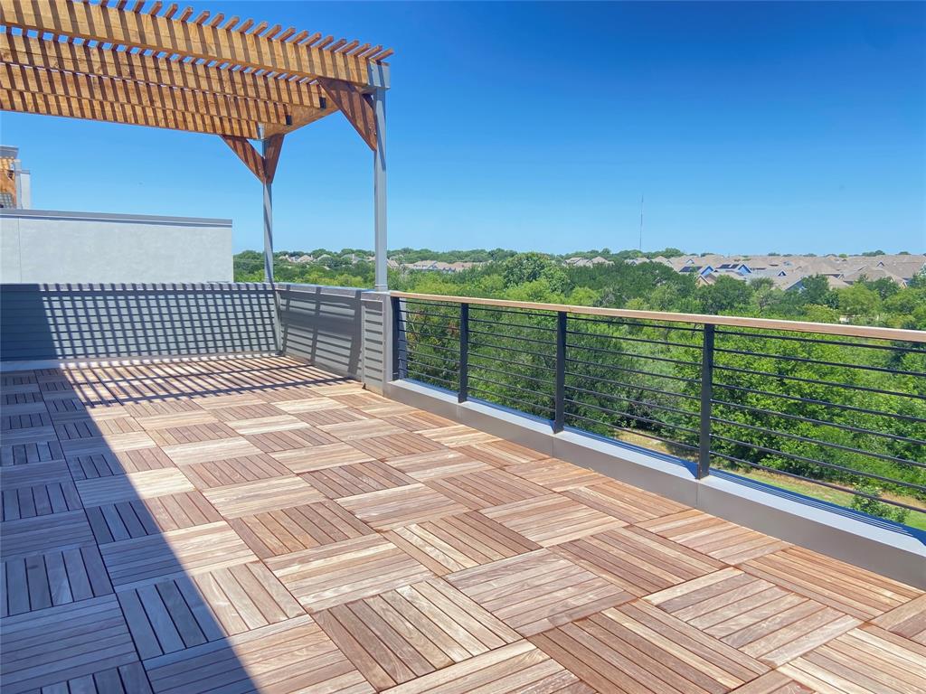 Sits on the 7-mile Blue Trail! Modern luxury meets refined living in this 3-story residence - with an elevator - overlooking nature. Walls of glass frame expansive views while an elevator provides effortless access to all three levels. Hardwood floors, waterfall-edge quartz countertops, under-lit floating vanities, and thoughtful designer details create a quiet sophistication reminiscent of a luxury hotel suite.  The open-concept design offers generous living spaces, soaring ceilings, and abundant natural light throughout. A versatile third-floor retreat serves as private guest quarters or a large family room, opening to an impressive 35-by-10-foot rooftop terrace with panoramic trail views.  Step outside to your own private outdoor sanctuary, where open skies and gentle breezes replace the noise of the city. From the community pool, direct access to the seven-mile Blue Trail invites morning walks, evening bike rides, and effortless connections to nearby restaurants—no car required.  Ideally positioned in the Carrollton–North Dallas corridor with easy access across the Metroplex, this residence is also pre-wired for EV charging. Every detail has been thoughtfully considered, creating a home that is as effortless as it is elegant.  Construction is scheduled for completion mid-June.