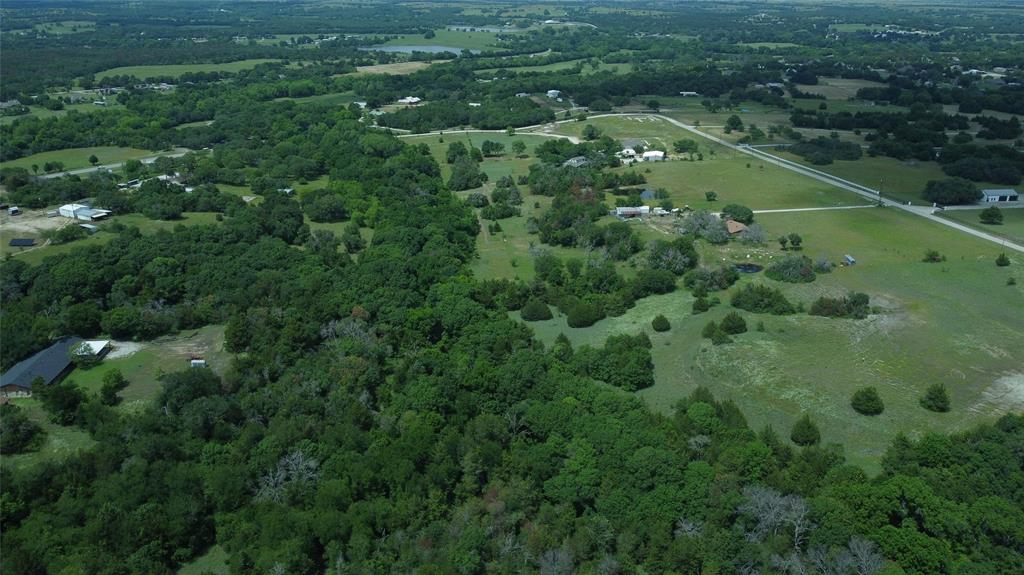 Sprawling 20.05 acers located just 3 miles n of Decatur Tx with vast terrain adding many building spots throughout the property. Everything from running water from the Catlett creek to a natural clear pond. This stunning acreage provides everything from scatted pecan trees to 100-year oak trees. Costal and native grass scattered throughout the property providing plenty of grazing for livestock. The property is equipped with a 30 by 40 barn with 2 stalls and loading shoots. The property also features a 12 by 24 2 story cabin with covered storge or parking. Come take a look at stunning piece of property.