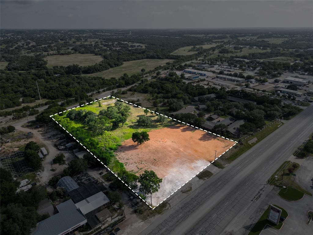 LOCATION is key to SUCCESS. Located on Hwy 377 between Bypass cutoff for town and Hwy 4 HEB-Kroger intersection.  Almost 40K+ per day traffic count on HWY 377 & EVERYONE in Hood County has to pass through this corridor to go north or south.  325' of Hwy 377 frontage and 353' of frontage on Old Granbury Rd.  City water & sewer available. Metal building has been removed and property is being leveled.  New survey, topo, & tree survey available. Information deemed reliable but Buyer & Agent should verify. Buyer & Buyers Agent to verify all permit requirements with City of Granbury.