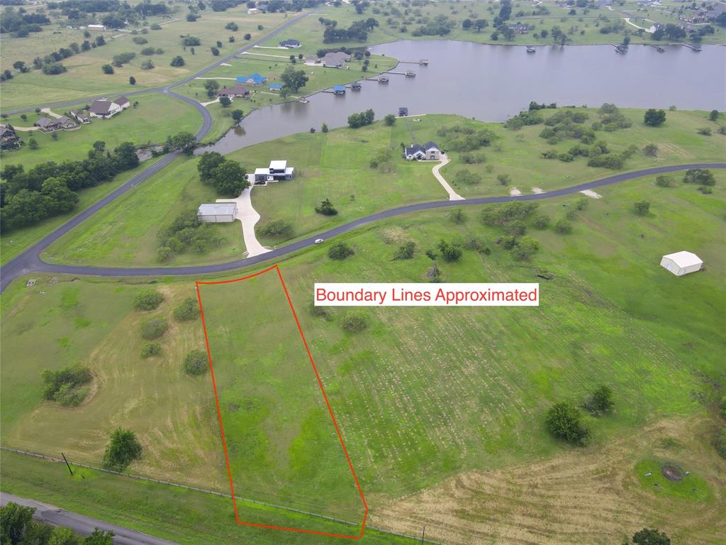 Imagine ending each day with a peaceful drive home through a gated lakeside community, where quiet country roads, wide-open skies, and glimpses of Richland Chambers Lake remind you why you chose to build here. Lot 134 on Lake Vista Drive offers 1.01 acres of gently rolling land, creating the perfect setting for the custom home you've always envisioned—whether it's a modern farmhouse with a wraparound porch or a cozy retreat designed for gathering family and friends.
Although the property is off the water, the lake is always just moments away. SouthPoint property owners enjoy access to a private community boat ramp, making spontaneous days of boating, fishing, and sunset cruises effortless. When you're ready to unwind closer to home, cool off in the community swimming pool, relax beneath the shaded cabana, or simply enjoy the peaceful surroundings that make this neighborhood so inviting.
With beautiful peekaboo lake views, room to spread out, and a relaxed atmosphere that blends lake living with country charm, this homesite offers more than just a place to build—it offers a place to create memories for years to come. SouthPoint features quality site-built homes with minimum square footage requirements, helping preserve the beauty and value of this sought-after Richland Chambers Lake community. If you've been waiting for the perfect place to turn your dream of lake living into reality, this could be the one.