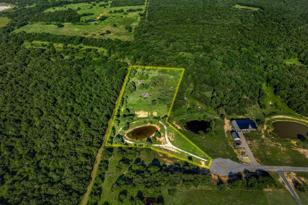 Come see one of the best developed lots located in The Ranches of Blackjack Meadow & enjoy endless views of cotton candy skies on over 5 acres. Located on a private cul-de-sac street & partially cleared with a drilled well, this lush setting is ready for development. Owner expanded existing pond for a larger water view.  Enter onto the rock driveway to find a rock pathway around the pond.  Build your own custom home including 1 large animal allowed per acre. Back of the property is separated with cattle fencing & natural dry creek bed on the eastern side.  Gorgeous trees & greenery set this spacious lot apart from others.  Quiet living with lower taxes & serene surroundings. $10,000 water well added in 2022.  Located just southeast of Nocona with easy access to HWY TX-59.