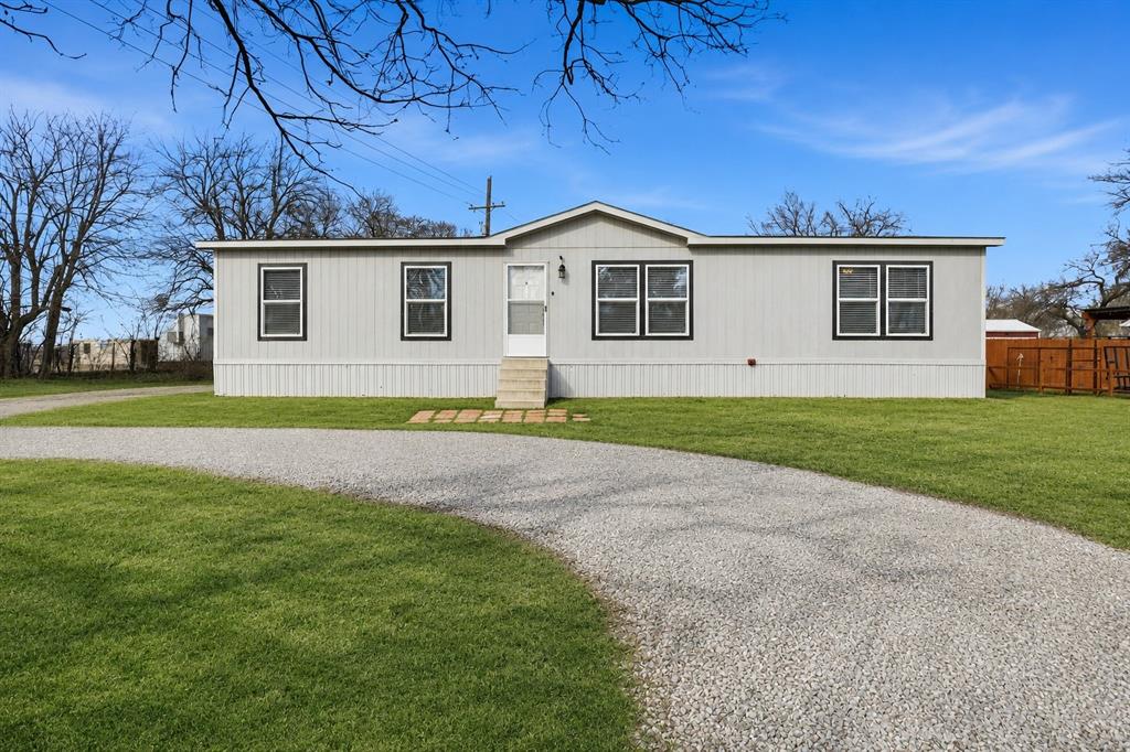 Well-maintained Clayton 4-bedroom, 2-bath doublewide home set on over an acre in Trenton, TX, offering peaceful views of a wide open pasture directly in front. The open floor plan features a spacious family room that flows into the kitchen and dining area, creating a bright and inviting layout. The kitchen includes an island and breakfast bar with ample counter space, ideal for everyday living or entertaining.

The split-bedroom design provides added privacy, with the primary suite featuring double sinks in the bathroom. Additional highlights include a dedicated utility room, generous storage throughout, and an outbuilding ideal for extra storage or equipment. Enjoy quiet country living with room to spread out while still offering convenient access to the DFW metroplex. This property qualifies for all loan types, making it a great option for a wide range of buyers.