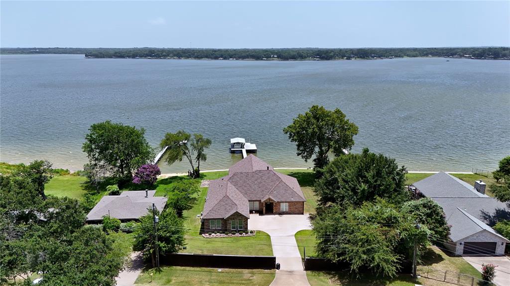 2019 Custom Built Home on Open Water! The house sits above the water facing southeast on a double lot. When you enter the front door you immediately see the open water through the floor to vaulted ceiling windows. Mornings on the back porch watching the sun rise with the breeze coming in off the water are truly amazing. The retaining wall was replaced in 2019 and has a concrete walkway. To maximize capacity, all bedrooms are large enough for multiple beds or bunk beds. The living area comes with a gas fireplace. There is a 12 x 5 safe room, 500 gallon buried propane tank and a 22K Generac whole house generator for back up power. The house was constructed to be ADA friendly.