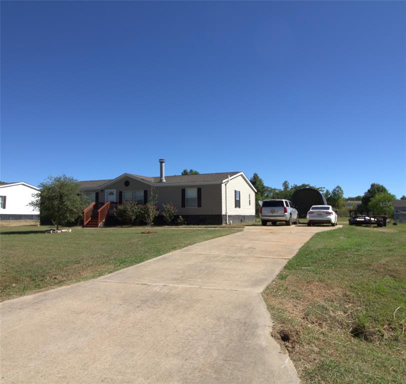 Freshly Remodeled 2012 Doublewide home, sitting on almost .75 acre lot.  This home has 4 bedrooms, 2 baths.  New floors, paint and blinds throughout.  The roof is only 2 years old.  Home has large shop or storage building in the backyard.  Home is on community water and sewer, has concrete driveway.  Decks front and rear.