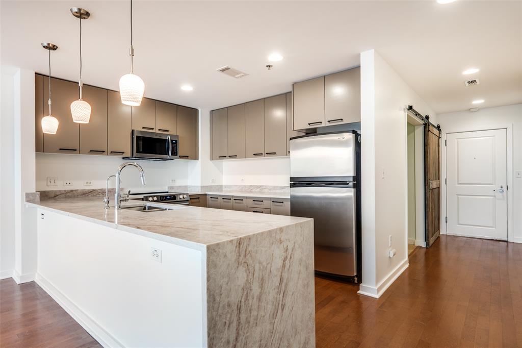 Just UPDATED with new quartzite taj majal countertops in the kitchen and bathrooms and freshly painted cabinetry in kitchen and both bathrooms.   This downtown Dallas two bedroom, two bath condo features an open floor plan with stunning west facing, city views of Reunion Tower, the Bank of America Building, and picturesque sunsets. The kitchen is equipped with a NEW stainless steel stove, dishwasher, and microwave...it also features granite countertops and significant cabinet storage. The large primary bedroom includes a well designed walk-in closet. The bathrooms offer large vanities with large designer mirrors and lighting...and new toilets.  The primary bath features a large soaking tub.  The Refrigerator and full-sized Washer & Dryer are included. This unit comes with the rare and highly coveted TWO seperate parking spaces, not tandem! If you only need one space, you can sell (or rent) your extra space...parking spaces have previously sold for $20,000.

Enjoy building amenities like a fitness center, resort-style pool, business center, and 24-hour concierge. Secure parking and controlled access ensure peace of mind. Located just steps from top dining, shopping, and entertainment, this condo offers convenience and luxury.