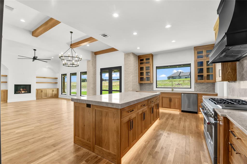 AMAZING NEW PRICE! Tucked away on 2.01 acres in prestigious Santana Ridge Estates within acclaimed Brock ISD, this exceptional 3,915 SF residence by M2 Luxury Homes blends refined luxury, warmth & functionality. Striking curb appeal, rich architectural details & thoughtfully curated finishes create an unforgettable first impression. Inside, an expansive open-concept layout unfolds beneath soaring ceilings & oversized windows that flood the home with natural light. The chef-inspired kitchen was designed to impress with commercial-grade appliances, inset oak cabinetry, dramatic drop-edge Taj Mahal quartzite island & counters, wet bar & spacious walk-in pantry. The centrally positioned dining area showcases overhead box beams, brick pillar accents & seamless access to the expansive covered patio for effortless indoor-outdoor entertaining. The living room exudes warmth & sophistication with a floating gas fireplace framed by arched built-ins & subtle French-inspired charm. A private office with French barn doors & bold accent wall creates an inspiring work-from-home retreat. With 5 bedrooms thoughtfully arranged throughout, the flexible floorplan accommodates both everyday living & multigenerational needs. The luxurious primary suite features a spa-inspired bath with massive walk-through dual-head shower, bold black soaking tub, statement tile wall with chandelier & pass-through access to the spacious laundry room with utility sink, cabinetry & drip-dry area. A second primary suite offers ideal guest accommodations, while the oversized flex suite with ensuite bath & direct patio access functions beautifully as a 5th bedroom, media room or private retreat. Upstairs, a huge bonus room with full bath & storage closet provides endless flexibility. Horses & laying hens permitted! Private septic, buried utilities, AT&T fiber & quick access to I-20, all just 10 minutes from Downtown Weatherford & I-20, and only 60 miles to DFW airport. Motivated to sell - bring all offers!
