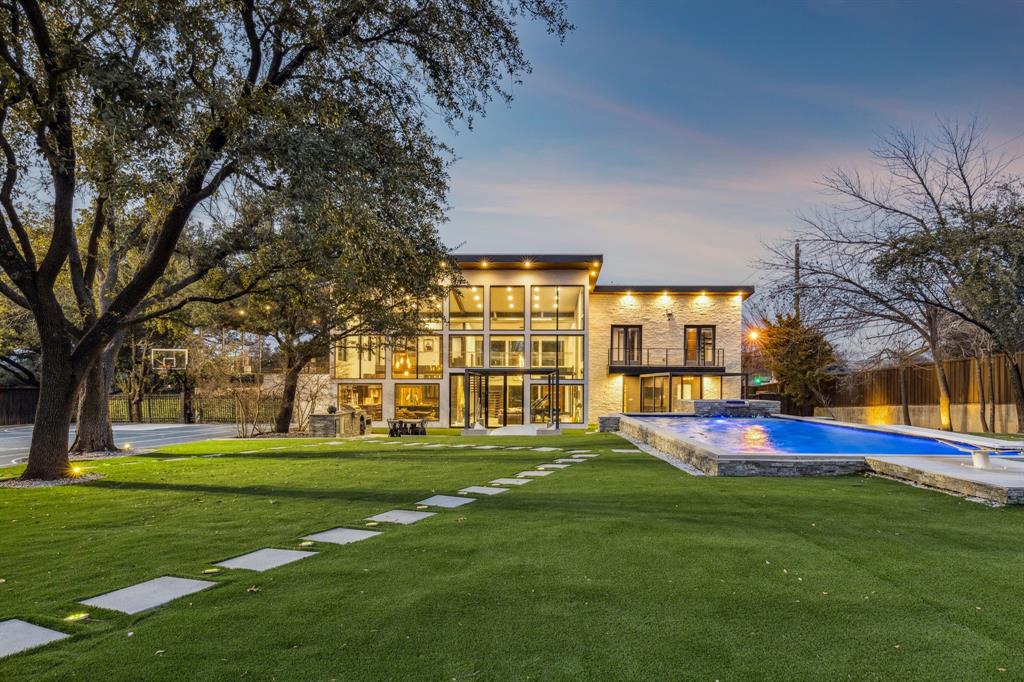 Located in the heart of Hillcrest Estates, 6766 Northaven Road is a striking custom home built in 2020 on a rare 0.942-acre lot. Designed for modern living and effortless entertaining, this 4,437-square-foot residence features an open-concept layout with dramatic floor-to-ceiling windows that flood the home with natural light and frame views of the beautifully maintained grounds. The first-floor primary suite offers a private retreat, while five bedrooms and five bathrooms provide space and comfort for family and guests. Outdoor living is exceptional, with approximately 1,000 square feet of porch space, a putting green, pool and spa, turfed backyard, tennis-sports court, and outdoor kitchen—ideal for hosting year-round. A three-car garage adds convenience, and the expansive outdoor areas offer potential to be incorporated into the home’s square footage. Centrally located near Dallas’ premier shopping, dining, recreation, and the private school corridor, this home is truly an entertainer’s dream.
