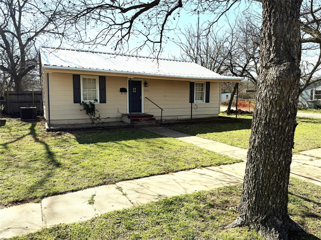 Here's a neat 2 bedroom, one bath home that would make a perfect starter home or investment property! With almost 1100 sq ft, this home features a new metal roof in 2024, a remodeled kitchen with custom cabinets, kitchen appliances, bathroom remodeled with a nice walk-in tiled shower in 2019 and a large, fenced back yard. Two older outbuildings in the back provide plenty of storage. Come take a look at this one!