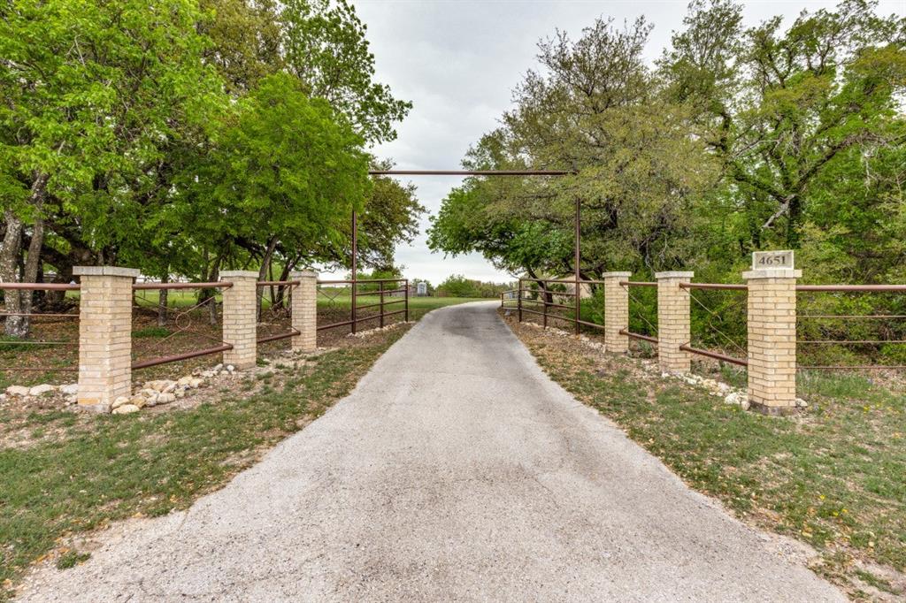 Rare Country Ranch Home For Lease. 4 bedrooms, 2 baths, 2 car garage on approximately 2 acres. Privacy like few others. Gates at Entrance to property and gate leading to front porch  Chain linked fenced yard for dogs and kiddo's.  New AC - many hardwood bookcases, cupboard's, bathrooms cabinetry. Terracotta style flooring throughout much of home. C-tile floors in bathrooms. Beautiful Talavera tiles bathrooms countertop. Updated lighting & fixtures..30 foot hallway of terracotta tiles leads to Owners Suit at the end of the hallway. Spacious room with separate access to outside fenced yard. Well water and Septic sewer. Covered Breezeway from garage to front door. Utility room plus Office Study. Plenty room for guest parking. Note the beautiful views from every window in the home