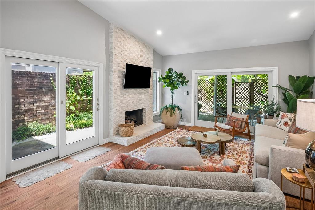 Welcome home to this beautifully designed 3-bedroom, 3-bathroom townhome with a 2-car attached garage, offering the perfect blend of style, comfort, and convenience. Filled with abundant natural light, this home features an open-concept floor plan where the kitchen flows seamlessly into the dining area and spacious living room, creating an ideal space for both everyday living and entertaining. The well-appointed kitchen overlooks the main living areas and offers generous cabinetry and workspace, while rich hardwood floors throughout the main level add warmth and elegance. A highly desirable first-floor bedroom and full bathroom provide the perfect space for guests, multigenerational living, or a private home office. Upstairs, the spacious primary suite is a true retreat featuring two walk-in closets and a private ensuite bath. An additional bedroom and full bath complete the upper level, along with ample storage throughout the home. Step outside to enjoy the inviting covered outdoor living area, perfect for relaxing or entertaining year-round. Residents enjoy outstanding community amenities, including expansive green spaces, two tennis courts, a resort-style swimming pool, and a clubhouse, offering an active, low-maintenance lifestyle. Ideally located just minutes from premier shopping, popular restaurants, the LBJ Freeway (I-635), and the Dallas North Tollway, this home provides exceptional convenience with easy access to everything Dallas has to offer. Move-in ready and thoughtfully designed, this exceptional townhome combines flexible living spaces, desirable community amenities, and an unbeatable location.