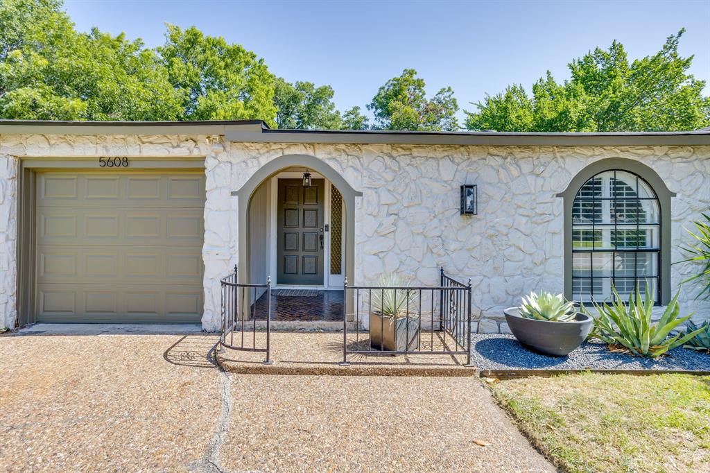 Nestled in the heart of Burton Hills and taken down to the studs in 2020, this one-of-a-kind home offers the perfect balance of timeless character and modern design. The stunning and unique exterior is defined by Texas limestone, graceful arched windows, curated mid-century modern landscaping, a new privacy fence, and a stately magnolia that makes an immediate impression. Inside, a spacious foyer unfolds into an open-concept living space where the kitchen, dining area, and oversized family room are seamlessly connected, with a wood-burning fireplace serving as the home's inviting focal point. Updated designer lighting, wallpaper accents, and a combination of hardwood, tile, and luxury vinyl flooring elevate every room while providing both beauty and functionality. Minutes from the River District, Shady Oaks Country Club, River Crest Country Club, and the Trinity River trails- this is a home you do not want to miss.
