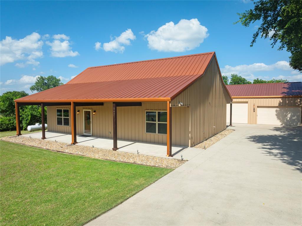 Talk about a property that truly has it all. This home offers the perfect blend of country living with the convenience of being just minutes from town. From the moment you pull into the driveway, the unique charm of this barndominium stands out—from the impressive shop out to the peaceful, covered porch in the back. Inside, the open and spacious floor plan provides plenty of room to make the space your own. Both bedrooms are generously sized, and there’s a flexible bonus room off the living area that can serve as an office, hobby room, or anything you need. The attic has been fully floored, giving you even more usable space—ideal for a game room, additional bedrooms, or whatever you imagine. Step outside and you’ll find a well-insulated 40x40 detached garage complete with a car lift, perfect for projects and outdoor hobbies. Home has a generator for backup and solar panels that are paid in full.  There’s also a dog kennel and a covered outdoor kitchen area, fire pit, making the property even more functional and inviting. **Also master bedroom and bath has handicap features

This home is truly move-in ready. Don’t miss your chance to make it yours.