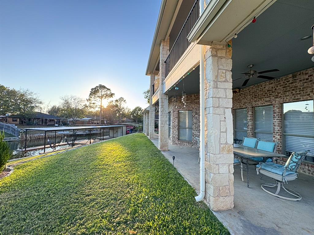 Welcome to this exceptional waterfront retreat located on a quiet cul-de-sac within the gated community of Indian Harbor. Situated on a spacious corner lot of nearly half an acre, this beautifully maintained home offers approximately 230 feet of canal frontage and direct access to the lake lifestyle you've been dreaming of. Recent updates include a new dock and retaining wall, roofing updates on the home and workshop, luxury vinyl plank flooring, and a new water heater. Inside, you'll find four generously sized bedrooms, two and a half bathrooms, open concept living space, dining room and a downstairs den. The primary suite opens to a covered patio overlooking the water, while the upstairs balcony captures expansive canal and lake views. A detached workshop with electricity provides additional flexibility for hobbies, storage, or workspace needs. Whether you're searching for a full-time residence or a weekend lake escape, this property delivers comfort, functionality, and outstanding waterfront amenities.