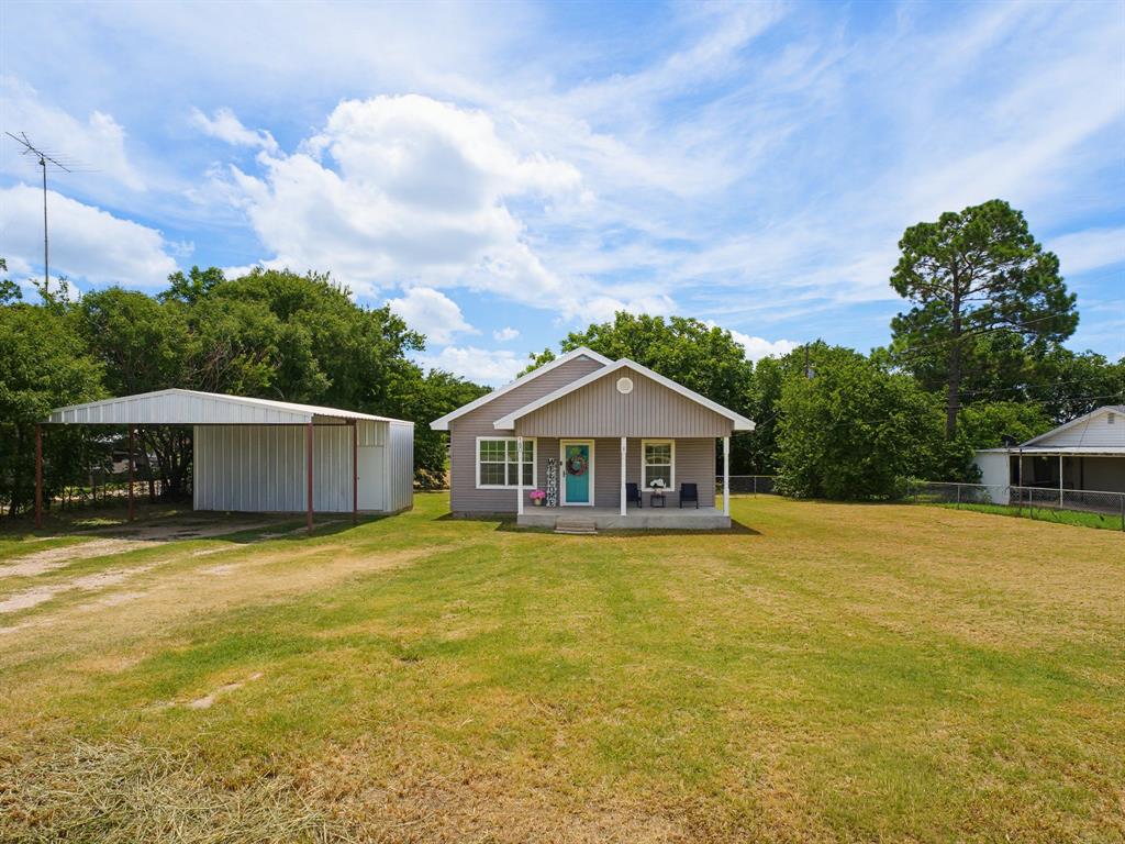 Step into a home where timeless charm and simple living come together. Nestled on a generous 0.44-acre lot, this inviting 3-bedroom, 2-bathroom home offers 1,344 square feet of comfortable living space with plenty of room to make it your own. From the moment you arrive, the welcoming covered front porch sets the tone, offering the perfect place to enjoy your morning coffee or unwind in the evenings. Inside, you'll find a functional layout designed for everyday living, while the home's character evokes a sense of nostalgia that's becoming harder to find. Out back, the spacious open patio overlooks an expansive backyard with endless possibilities for entertaining, gardening, play, or simply enjoying the outdoors with mature pecan trees. A storage shop provides extra space for tools, hobbies, or equipment, and the covered carport adds convenience and protection for your vehicles. Whether you're searching for your first home, looking to downsize, or simply appreciate the warmth and charm of a property with room to breathe, this one offers the perfect blend of comfort, character, and outdoor space. Come experience the feeling of home and create new memories in a place that celebrates the best of yesterday while welcoming tomorrow.