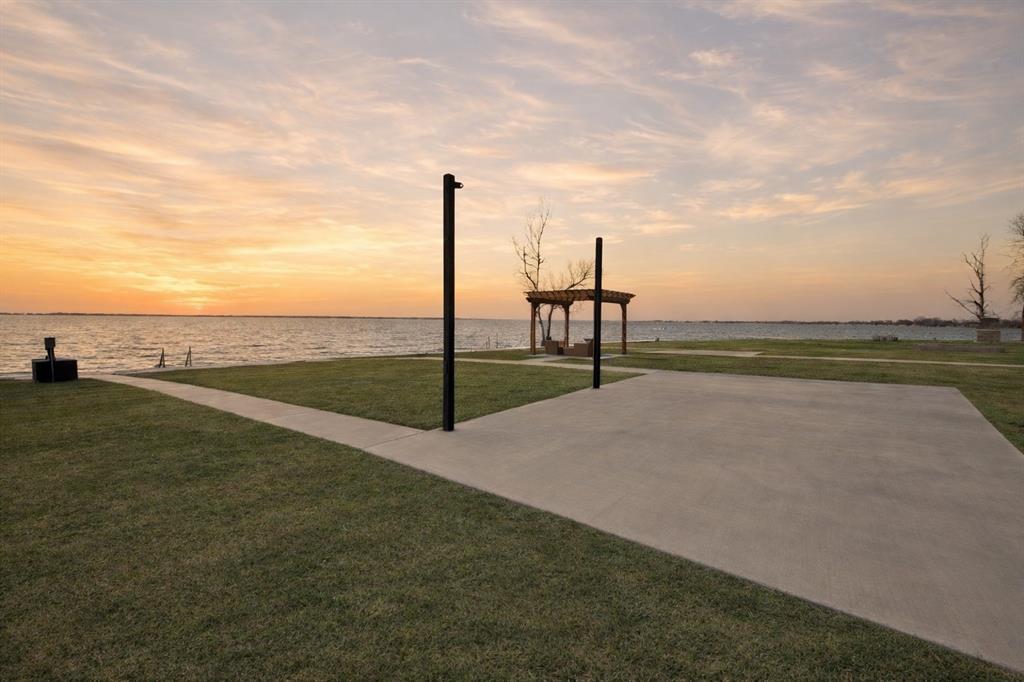 Wake up to lake breezes and wind down with unforgettable sunsets at this waterfront RV lot in the luxury, gated RV community of Peninsula Point on Richland Chambers Lake—perfectly positioned halfway between Dallas and Houston for easy weekend escapes or extended stays. Lot 98 is truly turnkey, with a concrete RV pad already poured, a steel retaining wall topped with an extra wide concrete sidewalk and water stairs in place. A sturdy shade sail setup is already installed so you can start enjoying the view from day in comfort and as an additional bonus feature the Seller has installed a lake pump and sprinklers to ensure that your piece of paradise stays enjoyable year round with a lush green lawn! Sunset skies reflect across the water nightly, creating the ideal backdrop for relaxed evenings by the lake from this prime location out on the end of the peninsula... it just doesn't get any better than this. 

Peninsula Point offers resort-style amenities with peace of mind, including monitored access via a park ranger, an outdoor clubhouse with grill station and laundry facilities, a swimming pool, boat ramp, boat storage when available, a fishing pier, playground, fenced dog potty area, and paved roads throughout the community. Utilities are already installed at each site for sewer, water, and electric, making setup simple and stress-free and as a money saving bonus, the Tap Fee has already been paid on this lot!

Whether you’re chasing sunsets, spending long days on the water, or enjoying quiet mornings by the shore, this waterfront RV lot delivers an effortless lake lifestyle in one of Richland Chambers Lake’s most sought-after RV communities. RV, Patio furniture and Kayak are not included in the listing.
