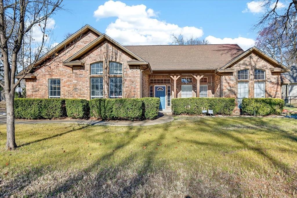 Impressive exterior on a corner, wooded lot just a few blocks from Cedar Creek Lake.  Spacious living area high ceilings, abundant natural light from large windows, and a striking stone fireplace.  The kitchen opens seamlessly to the living and dining areas and offers white cabinetry, stainless steel appliances, an island, and a generous eating bar- perfect for everyday living and entertaining.  The private primary suite includes double vanities, a separate soaking tub, and a walk-in shower.  Two guest bedrooms share a hall bath, plus a versatile flex room ideal for a home office or additional sleeping space.  Located in a wonderful neighborhood with amenities that include well-maintained roads, a swimming pool, dog park and two community boat launches.