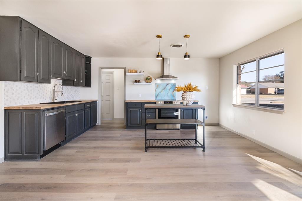 The home that checks all the boxes, with a modern remodel on S. China St: 3 Bed, 2 Bath, large double garage, with open concept floor plan.  The primary bedroom suite offers all new en suite bath & walk in closet. The kitchen has solid wood cabinets, butcher block countertops, stainless steel appliances, and island. One hundred percent of the home has received new flooring, new texture and paint. Two large living areas, and wood burning stove that adds so much coziness to the home right in the center. Close to the schools, and a 
spacious, extra deep backyard in the area, it is cross fenced for multi-purpose, like garden or animals, and has a matching storage shed as well.