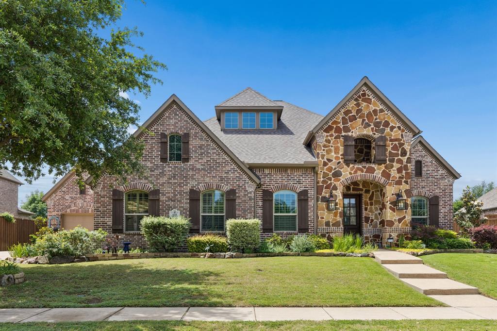 Stunning 1.5-story home in highly sought-after Murphy! Exceptional curb appeal features a stone-accented front elevation, cedar shutters, lush landscaping, mature trees and beautiful flower beds that create a park-like setting. The covered front porch with arched openings and striking stonework offers a warm welcome for family and guests.
Step inside and immediately appreciate the thoughtful design and spacious, well-appointed floorplan offering 5 bedrooms (4 on the main level), 4 full baths and 1 half bath. Hand-scraped hardwood flooring enhances the entry, kitchen and main walkways, while plantation shutters throughout  add timeless style and warmth.


Off the entry, the dining room feels distinct yet connected with elegant architectural details, while a private office with French doors creates the ideal work-from-home space. The very spacious inviting living room is anchored by a dramatic stone fireplace with handsome wood mantle and flows seamlessly into the kitchen, casual dining area and expansive first floor game or flex room.


The stunning open-concept chef’s kitchen is truly the heart of the home, featuring a large center island, beautiful cabinetry, abundant counter space and an inviting setting for gathering with family and friends.
Completing the main level is the expansive primary bedroom with luxurious spa like bath and two spacious walk in closets.


Upstairs offers a luxurious media room along with the private 5th bedroom and full bath—perfect for guests or multigenerational living. All bedrooms are generously sized with convenient bath access. Step outside to enjoy the expansive covered patio overlooking the private backyard situated on an oversized one-third-acre lot. Completing this incredible home is a spacious 3-car garage. Highly rated schools and convenient shopping and dining just minutes away make this a true dreamhouse!