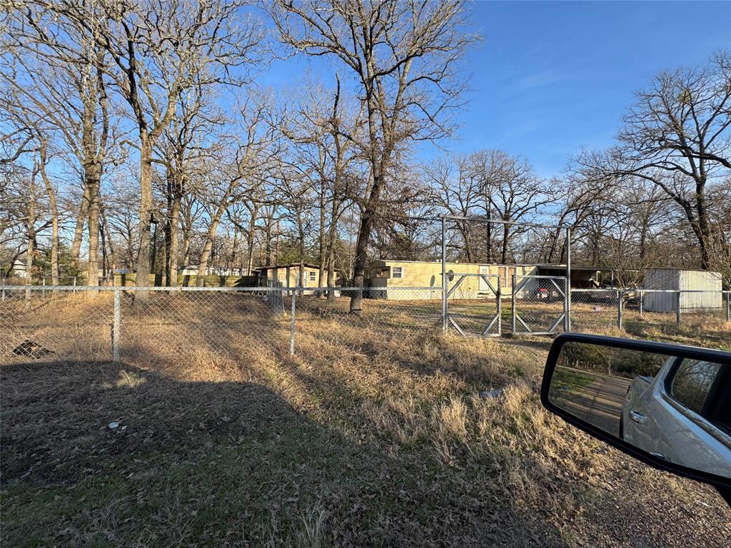 Excellent Opportunity!! On FOUR LOTS in Indian Harbor, in MABANK SCHOOLS, this much improving community has many new construction homes. Also has a neighborhood boat ramp. Take advantage of this wonderful opportunity before you miss out! With almost half of an acre, mostly fenced, this property features a mobile home plus a storage building. (Please don't disturb the tenant.)  Typically, single lots in Indian Harbor are 50x100. The age of mobile home is unknown.