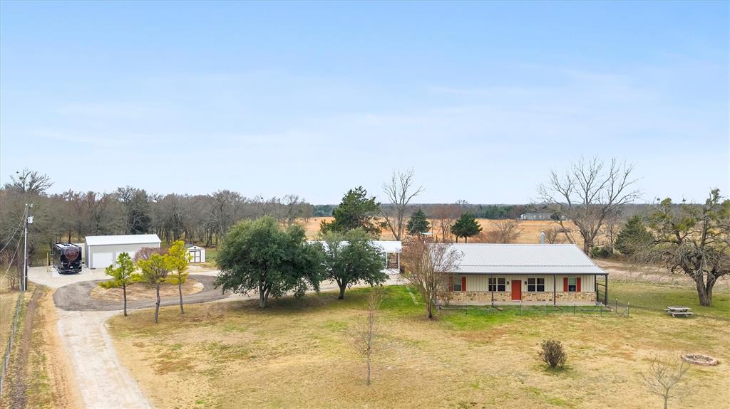 Come see this gorgeous ag exempt property on 10.02 in picturesque Quinlan TX!  This property boast 2 homes.  First is a 3 bedroom 2.5 bath barndominium with vaulted ceilings, rock wood burning fireplace, stained concrete floors, SS appliances with an open concept! Nice porches for entertaining and viewing the stunning sunsets. Second home is a new Casita Prat home that would be a perfect MIL home or second income rental! SS appliances,vinyl flooring, open concept 1 bedroom 1 bath! New to the property is a oversized 3 car garage, new septic, concrete RV pad with hookups, new fencing for dogs, additional dirt work to existing creek to add an additional 50 X 70 homesite!