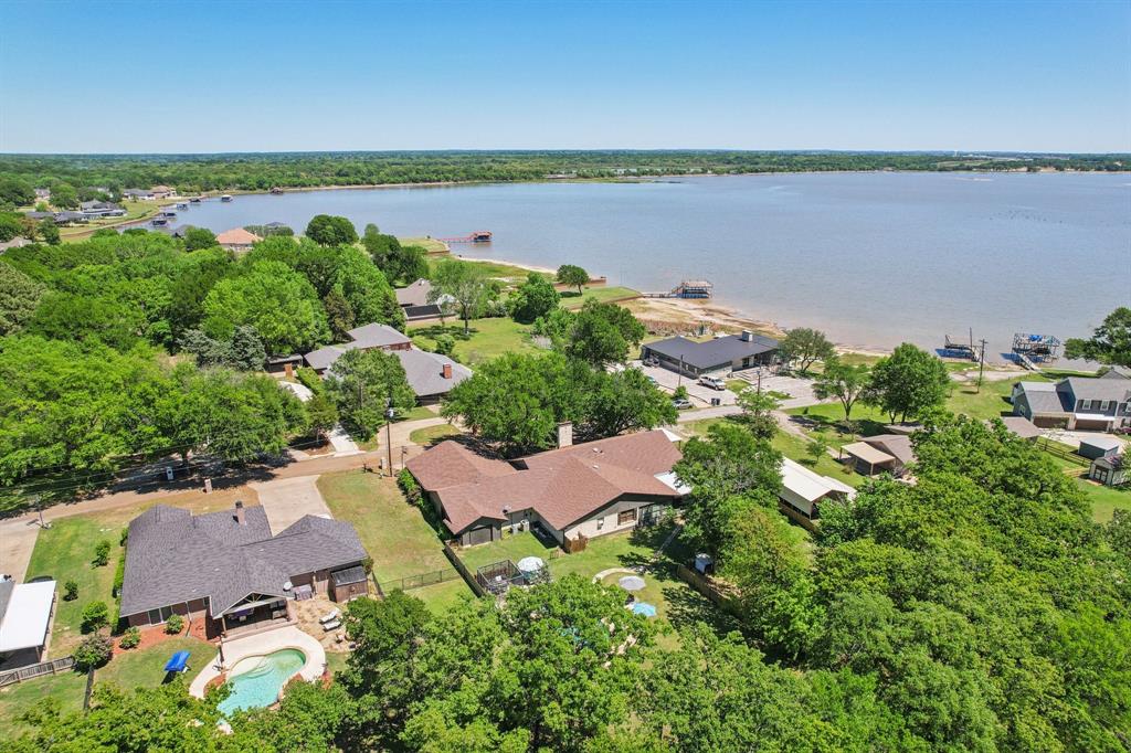 *** Sales Price Reduction*** Escape to your own personal vacation getaway! 1+ Acres in golf community on Cedar Creek Lake! This home offers lake views out front, private pool in the back, and be on the golf course in less than 5 minutes! This beautifully situated 3 bedroom, 3.5 bath home in the highly sought-after Cedar Creek Country Club. Nestled on approximately 1.1 acres with mature trees and stunning water views, this property offers both privacy and an ideal setting for entertaining. Designed with flexibility in mind, the home features three spacious living areas, giving you plenty of room to host, relax, and enjoy time with family and guests. The open layout flows seamlessly into the outdoor space where a sparkling pool creates the ultimate entertainer's dream. Enjoy lake access with a shared boat dock, making it easy to spend your days on the water and your evenings taking in peaceful views. A 3.5 car garage provides ample space for vehicles, lake toys, and storage. The kitchen is equipped with updated appliances and ample space for gathering, while the overall layout offers comfort, functionality, and room to make it your own. Whether you're looking for a full-time residence, weekend retreat, or exploring VRBO-income-producing potential, this property offers versatility and strong appeal for both personal use and investment. Surrounded by large trees and located within Cedar Creek Country Club, this home offers a rare opportunity to enjoy lake living with added amenities and a true sense of community. If you've been searching for value on the lake, this property delivers an incredible bang for your buck with space, views, and lake and country club amenities all in one - just in time for summer!  Buyers and Buyer's Agents to verify all information and details provided to guarantee the accuracy of information provided.
