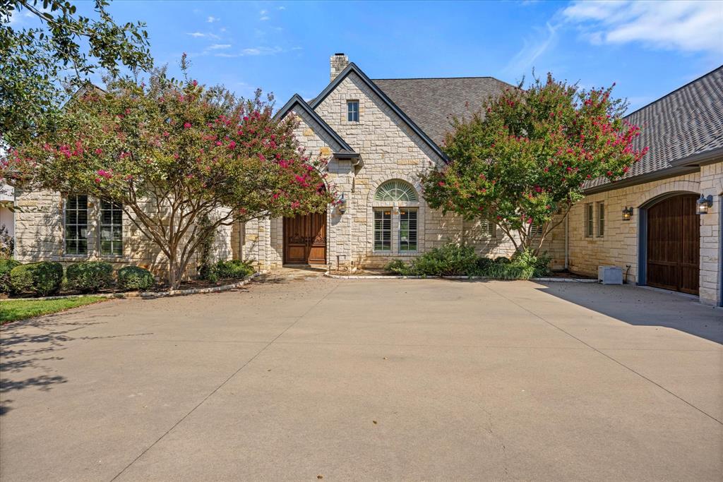 Welcome to an extraordinary waterfront estate that defines luxury living on Lake Granbury. Perfectly positioned to enjoy sweeping water views, this stunning residence offers a rare combination of elegance, comfort, and resort-style amenities.
From the moment you arrive, you’ll be captivated by the timeless architecture, mature landscaping, and a private setting that blends seamlessly with the natural beauty of the lake. Step inside to soaring ceilings, abundant natural light, and thoughtfully designed living spaces that maximize both comfort and entertainment.
The heart of the home flows effortlessly to the outdoor retreat, where a sparkling pool overlooks the open water, creating a serene backdrop for gatherings or quiet relaxation. The private boat dock makes it effortless to enjoy boating, fishing, and endless days on the water, while the generous lot size ensures privacy.
Whether entertaining guests or enjoying tranquil evenings by the lake, this estate embodies the pinnacle of waterfront living. With luxury finishes throughout and unrivaled amenities, it’s more than a home—it’s a lifestyle.
Property also includes a spider sprayer misting system on back patio and boat dock and versa lift in the garage.