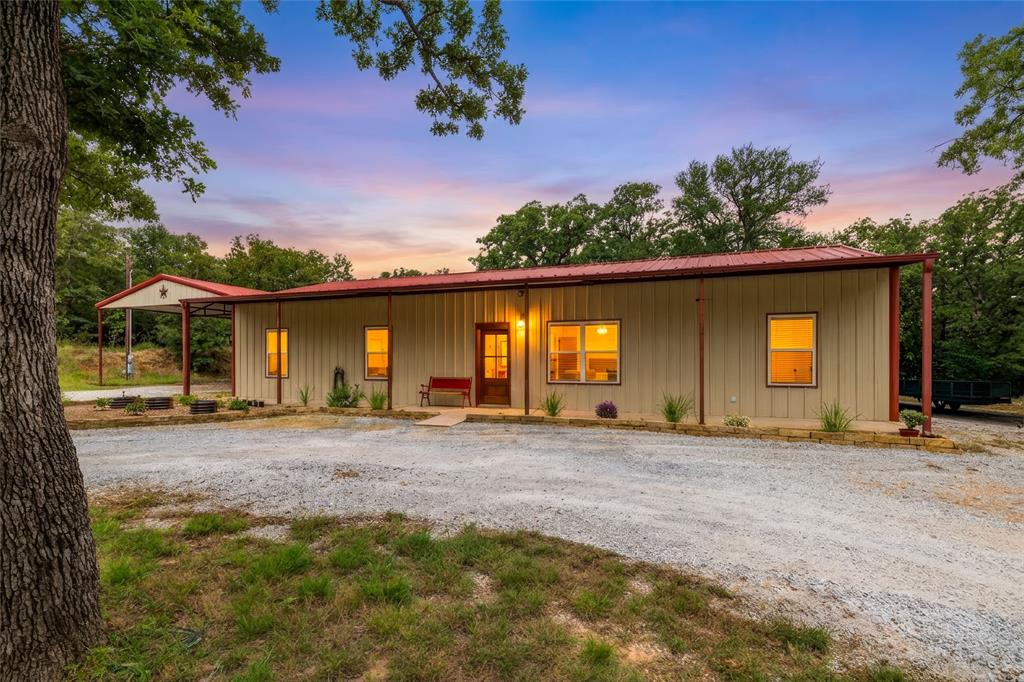 Welcome to your own slice of Texas paradise! Nestled on a quiet dead-end county road in the highly sought-after Paradise ISD, this beautifully updated barndominium offers the perfect blend of modern comfort & peaceful country living. If you've been dreaming of a property where you can bring the horses, raise chickens, enjoy wide open spaces, & escape the hustle & bustle of city life, this is it. The home features 3 beds, 2 baths, & an inviting open-concept layout designed for everyday living & entertaining. Recent updates include granite countertops, fresh paint, updated lighting, stained concrete floors, solid wood exterior doors, & new interior trim, creating a move-in-ready home with rustic charm & modern finishes. Step outside & experience country living at its finest. Equestrian enthusiasts will appreciate the 20x30 horse barn, cross fencing, & horse-friendly surroundings with plenty of room for animals. The custom chicken coop makes it easy to gather fresh eggs & embrace a more self-sufficient lifestyle. Mature trees, cleared underbrush, & well-maintained grounds provide a beautiful mix of shade & open pasture. Additional improvements include a 30x40 shop with electricity and two 240 volt 50 amp plugs, 14' tall 25x30 carport, RV hookup with water, electric, and septic, separately fenced pet safe backyard, electric gated entrance, refinished gravel driveway, & full perimeter fencing for privacy & security. Whether you're looking for a hobby farm, horse property, homestead opportunity, or simply a peaceful place to enjoy the country lifestyle, this property delivers. Conveniently located 15 minutes from Springtown, 20 minutes to Decatur, 45 minutes to Weatherford, & 35 minutes to Alliance, you'll enjoy rural tranquility without sacrificing convenience. Come experience the freedom, fresh air, sunsets, & star-filled nights that make country living so special.